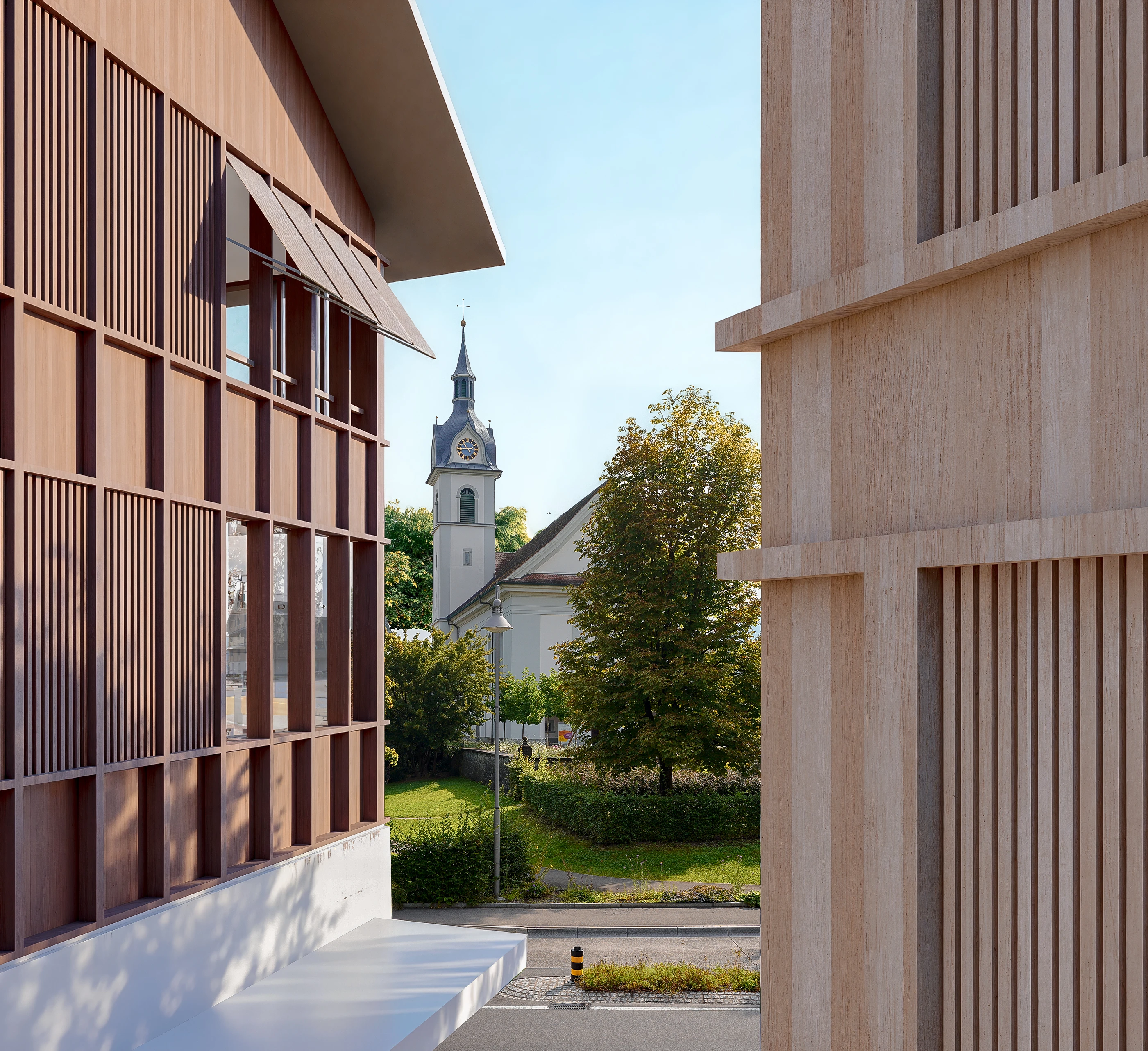 Timber facades framing the view of a village church tower